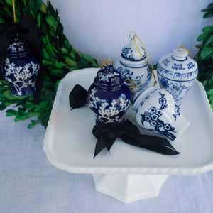 Blue and white ginger jar ornaments on a white compote.
