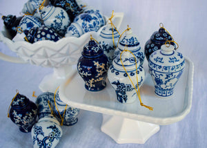 Set of six blue and white ginger jar ornaments on a white compote.